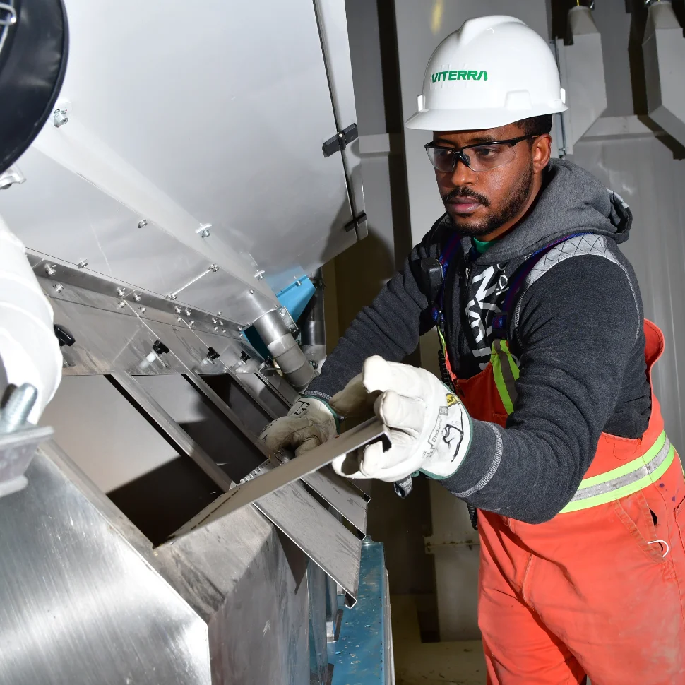 Employee bagging product at Belle Plaine processing facility