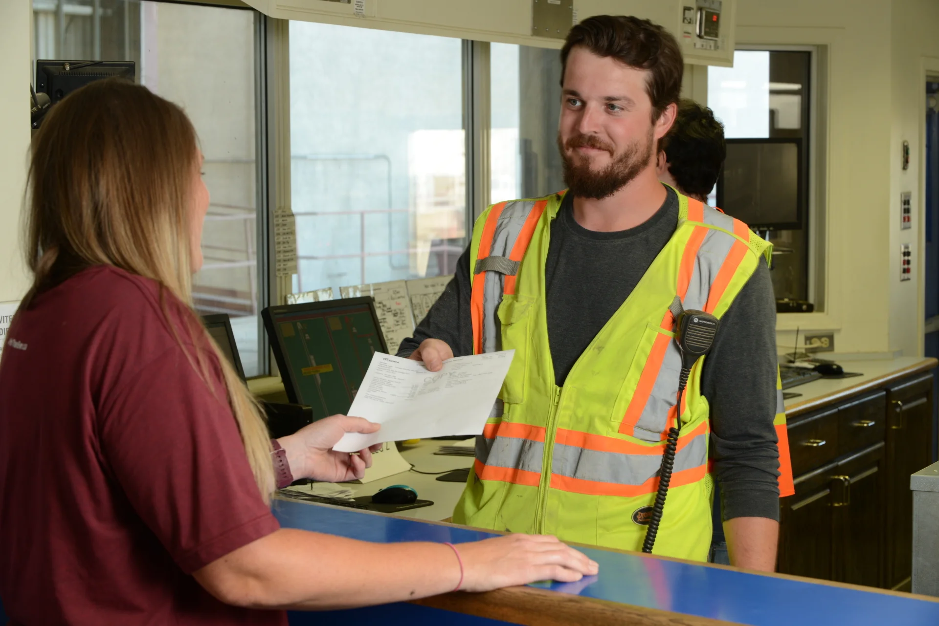 Colleague providing receipt to producer customer